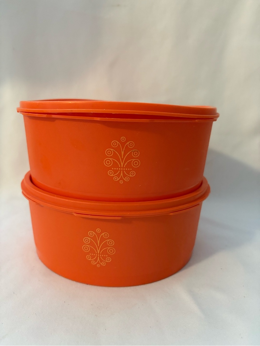 2- Tupperware Servalier lidded round orange containers with starburst lids